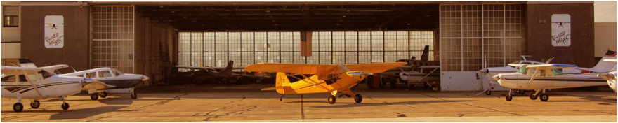 General Aviation aircraft in front of a hanger 